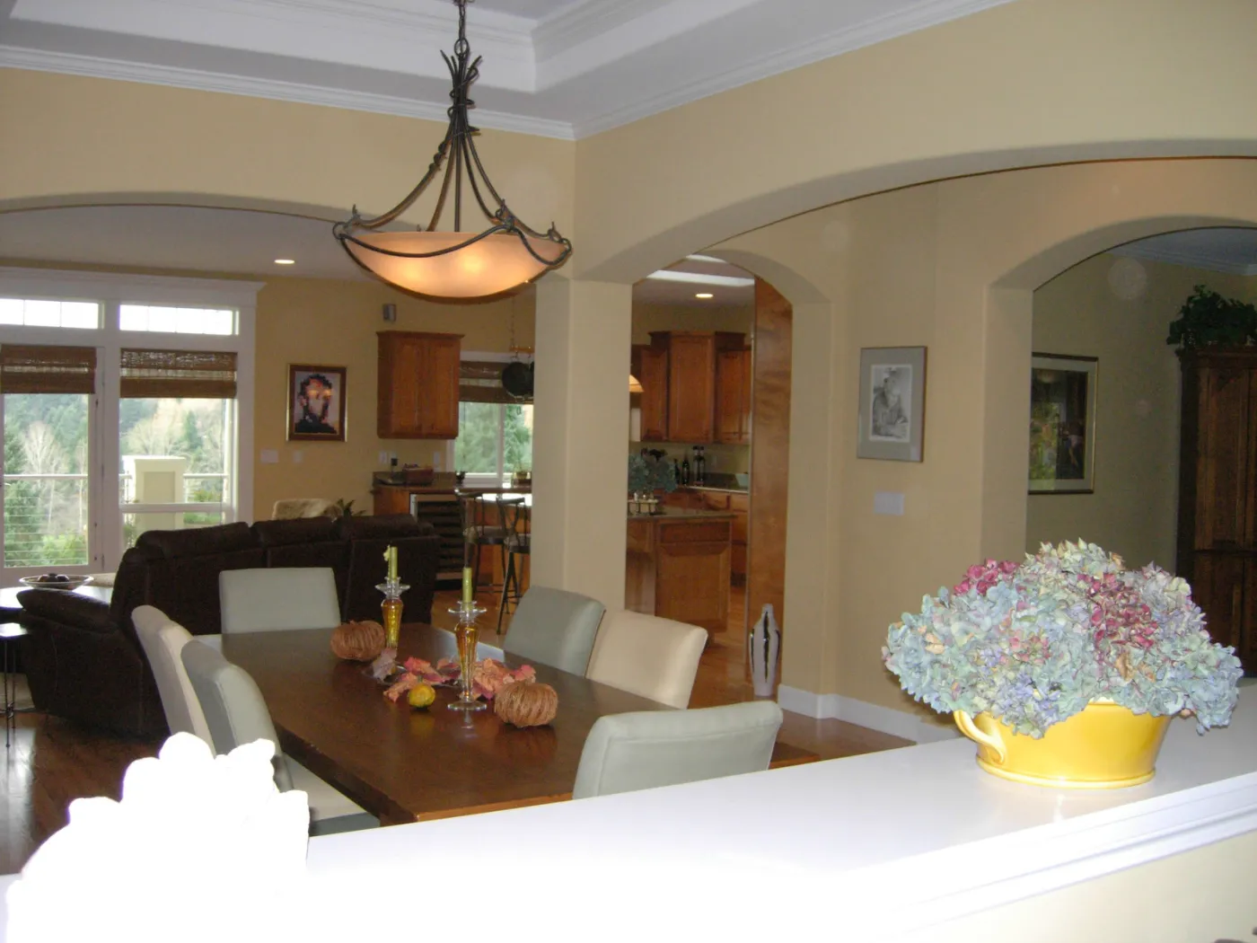 Traditional remodel: dining room with a chandelier, wainscot and a bay of windows